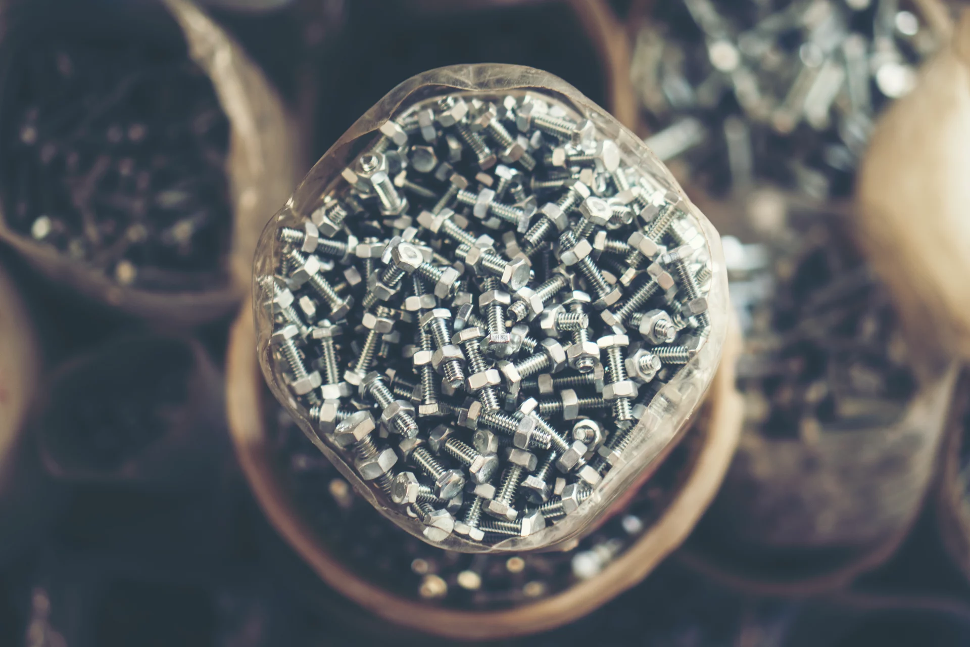 Stack of bolts and metal accessories in workshop